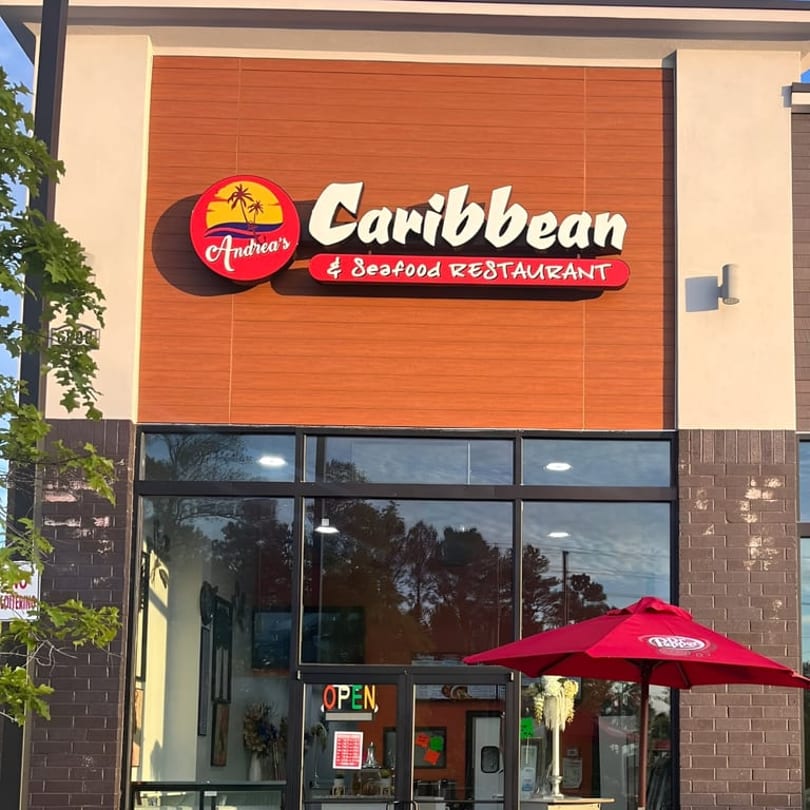 Andrea's Caribbean & Seafood Restaurant exterior with a red umbrella and "OPEN" sign.