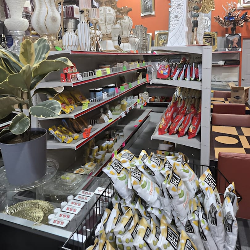 Shelves filled with various packaged goods and snacks, with restaurant seating visible in the background.