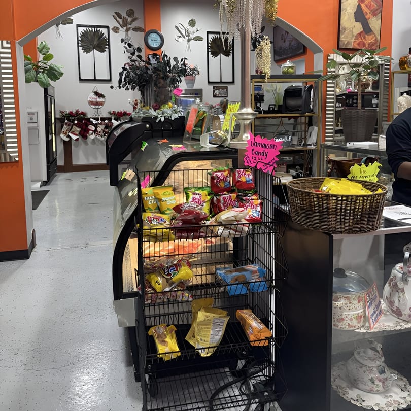 A Jamaican restaurant interior with a display of snacks and candy, and festive holiday decorations.