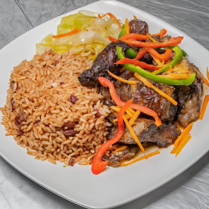 Jamaican brown stew chicken with rice and peas, and steamed cabbage on a white plate.