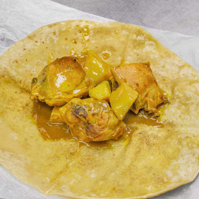 Curried chicken and potatoes on a flatbread, a Jamaican dish from Andreas Caribbean & Seafood Restaurant.